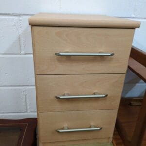 3 drawer beside table.