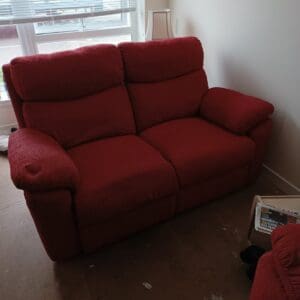 Red fabric two-seater sofa