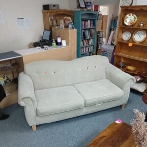 Grey fabric sofa with colourful button details
