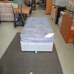 Single bed with blue mattress