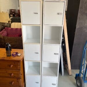 Two white tall storage units
