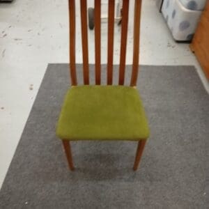 Wooden dining chair with green fabric seat
